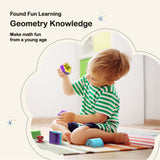 A white, blond little boy wearing green-white striped clothes playing My Geo-Blox : Sorting Blocks Set Toy for Kids - BEST LEARNING